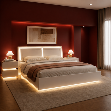 A modern white platform bed with integrated LED backlighting on the headboard and base, styled in a contemporary bedroom with a dark red accent wall, matching side tables, and warm ambient lighting.