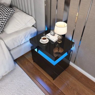 Black LED coffee table in a living room setting with a lamp and cup.